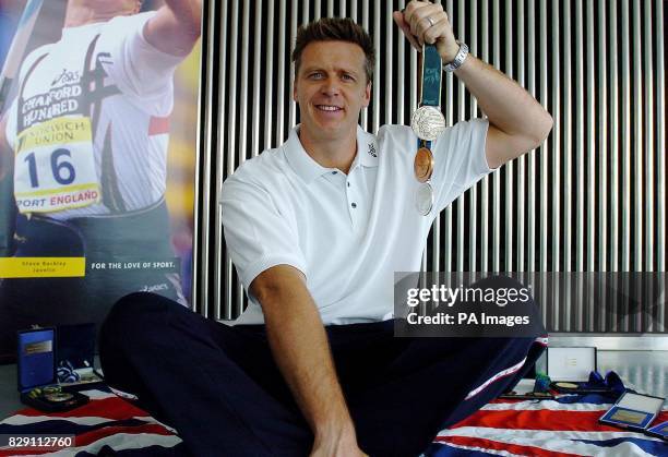 Javelin-thrower Steve Backley proudly displays his medals at City Hall, London, where he announced his impending retirement from international...