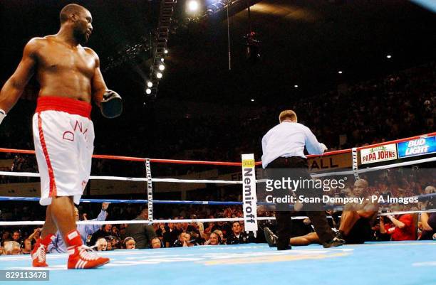 Referee Dennis Alfred counts out America's Mike Tyson after he is knocked out by England's Danny Williams in the fourth round of their Heavyweight...