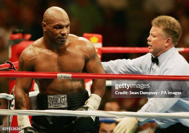 Referee Dennis Alfred counts out America's Mike Tyson after he is knocked out by England's Danny Williams in the fourth round of their heavyweight...