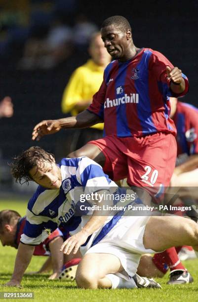 Queens Park Rangers' Gareth Ainsworth is tackled by Crystal Palace's Darren Powell during their pre-season friendly match at Loftus Road, west...