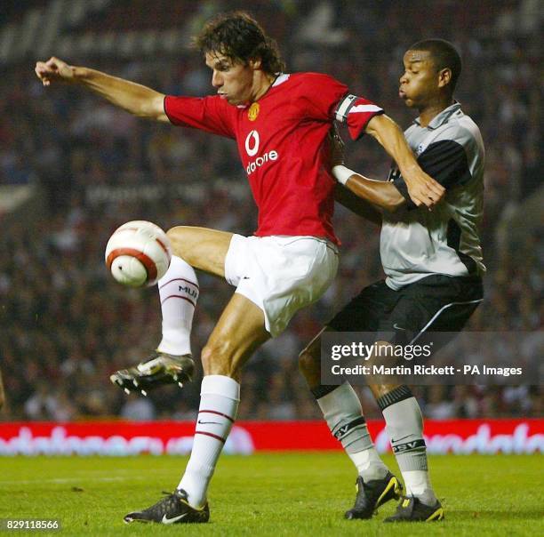 Manchester United's Ruud Van Nistelrooy is watched closely by PSV Eindhoven's Jurgen Colin during their Vodafone Cup match at Old Trafford in...