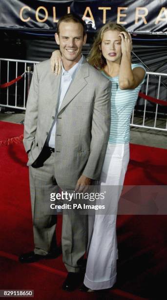 'Collateral' cast member Peter Berg and his girlfriend, actress Estella Warren, arrive at the premiere of the film at the Orpheum Theater in Los...