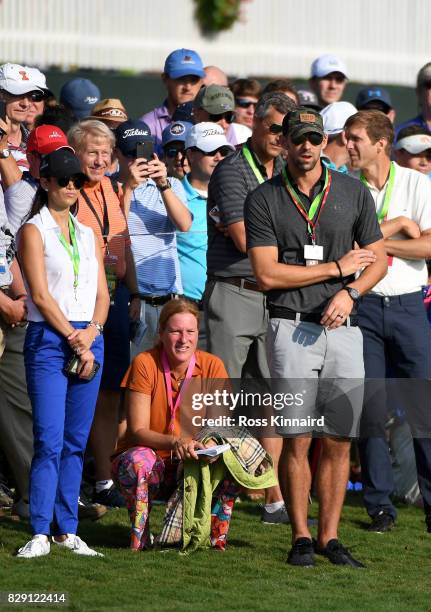 Swimmer Michael Phelps and his wife Nicole Johnson look on during the first round of the 2017 PGA Championship at Quail Hollow Club on August 10,...