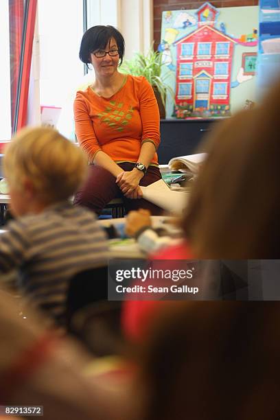 Teacher leads discussion with fourth-grade children in a classroom in the elementary school at the John F. Kennedy Schule dual-language public school...