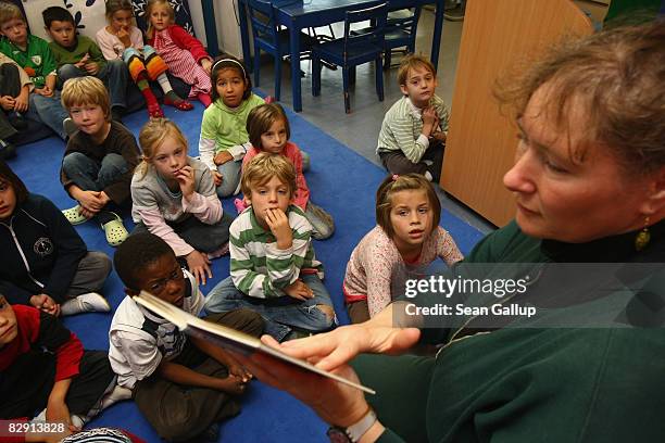 Teacher leads discussion with second-grade children in a classroom in the elementary school at the John F. Kennedy Schule dual-language public school...