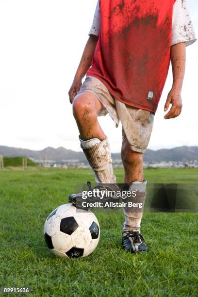 cropped view of muddy footballer - dirty sports uniform stock pictures, royalty-free photos & images