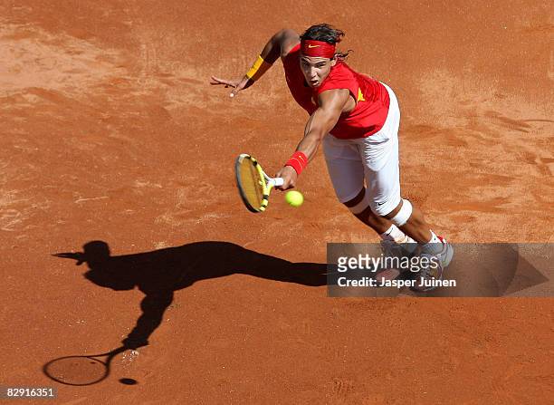 Rafael Nadal of Spain returns a backhand to Sam Querrey of the United States during day one of the semi final Davis Cup match between Spain and the...