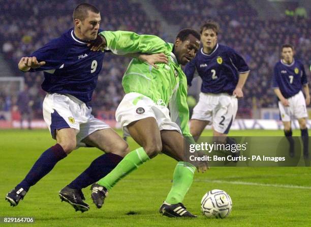 Scotland's Steven Thompson battles with Nigeria's Isaac Okoronkwo for the ball during the friendly International match at Pittodrie Stadium,...