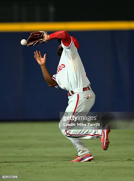 Shortstop Jimmy Rollins of the Philadelphia Phillies makes an error on a popup in the seventh inning during the game against the Atlanta Braves at...