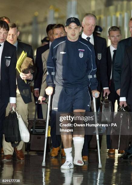 England's Danny Murphy hobbles through Kansi International airport, Japan as the England team arrive for their friendly match against Cameroon. THIS...