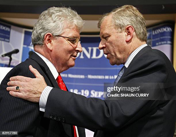 Nato Secretary-General Jaap de Hoop Scheffer and British Defence Minister Des Browne speak after adddressing a press conference in central London, on...