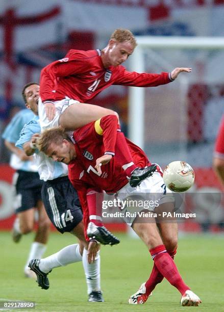 England's Nicky Butt and David Beckham collide as they challenges Diego Simeone of Argentina for the ball during their second Group F match in the...
