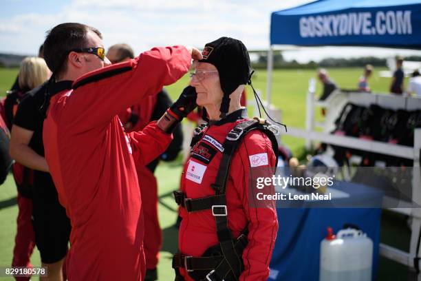 Former paratrooper Fred Glover receives final equipment adjustments ahead of a skydive at the Old Sarum airfield on August 10, 2017 in Salisbury,...