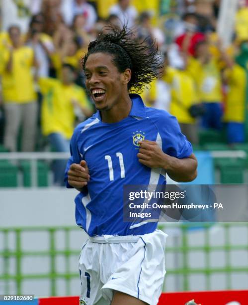 Ronaldinho celebrates after scoting for Brazil during the World Cup quarter-final match between Brazil and England at the Ecopa stadium, Shizuoka,...