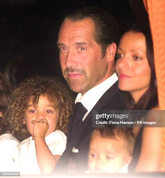 England goalkeeper David Seaman holding his daughter Georgina on a coach at Heathrow Airport, London. The England team have arrived back from Japan...