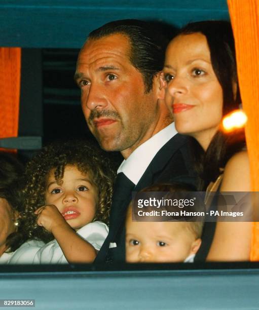 England goalkeeper David Seaman holding his daughter Georgina on a coach at Heathrow Airport, London. The England team have arrived back from Japan...