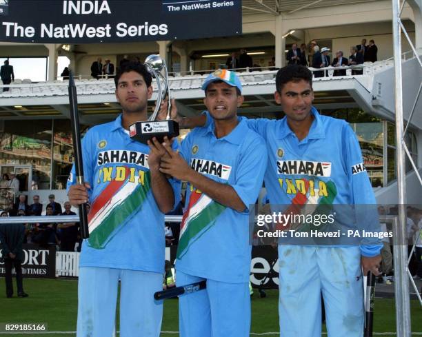 India's Yuvraj Singh, Sourav Ganguly, and Mohammad Kaif celebrate with the trophy after The NatWest Series final against England at Lord's Cricket...