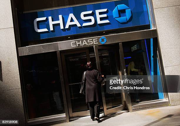 Woman enters a Chase bank branch near the corner of Wall Street and Broad Street September 19 in New York City. The White House announced a plan that...