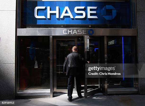 Trader on the New York Stock Exchange enters a Chase bank branch near the corner of Wall Street and Broad Street September 19 in New York City. The...