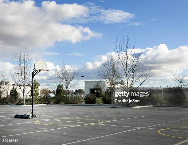 portable basketball hoop in empty parking lot - abandoned playground stock pictures, royalty-free photos & images