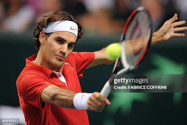 Switzerland's Roger Federer returns a ball to Belgium's Kristof Vliegen during their Davis Cup World Group Play-offs tennis game on September 19,...
