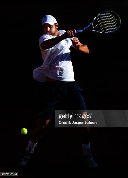 Andy Roddick of the United States returns a shot to David Ferrer during day one of the semi final Davis Cup between Spain and the United States at...