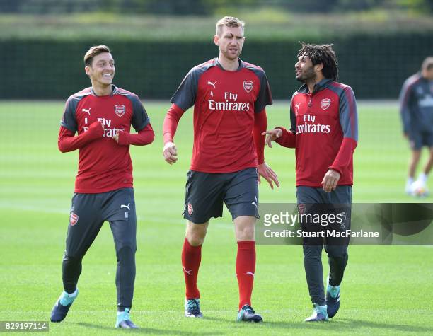 Mesut Ozil, Per Mertesacker and Mohamed Elneny of Arsenal during a training session at London Colney on August 10, 2017 in St Albans, England.