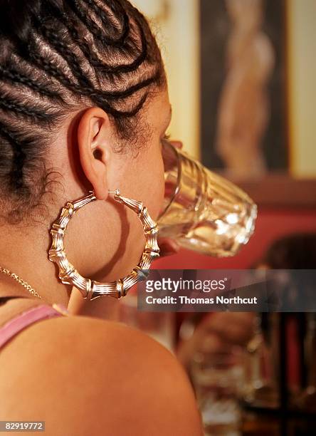 girl with hoop earring drinking water - hoop earring bildbanksfoton och bilder