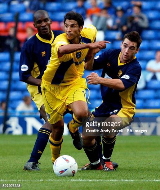 Coventry's Youssef Chippo tries to evade Wimbledon Alex Tapp, during their Nationwide Division One match at Wimbledon's Selhurst Park ground in...