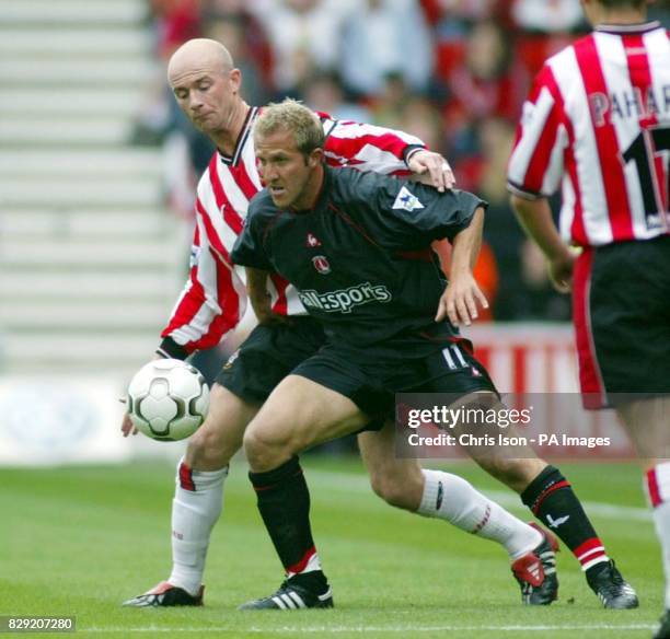 Chris Marsden of Southampton is held off by Charlton's John Robinson during their FA Barclaycard Premiership match at Southampton's St Mary's...