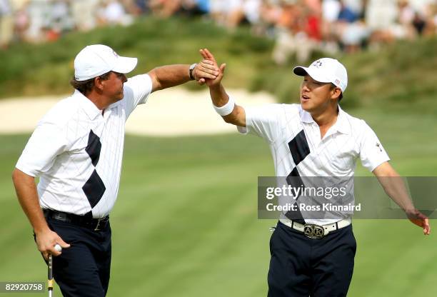 Phil Mickelson and Anthony Kim of the USA team celebrate on the ninth green during the afternoon four-ball matches on day one of the 2008 Ryder Cup...