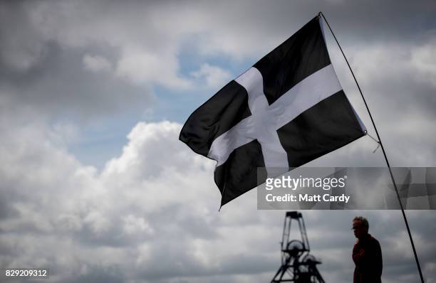 The Cornish flag flies as people listen as Labour leader Jeremy Corbyn speaks at a campaign rally at Heartlands in Camborne on August 10, 2017 near...