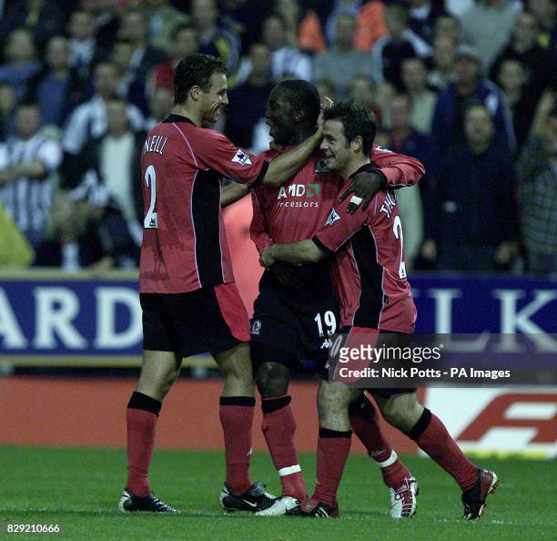 Blackburn Rovers's Dwight Yorke celebrates his penalty goal with Lucas Neil and David Thompson during the FA Barclaycard Premiership game at the...