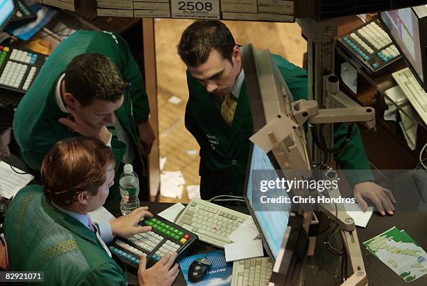 Traders and specialists look over terminals on the floor of the New York Stock Exchange September 19, 2008 in New York. Wall Street extended a rally...