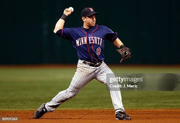 Shortstop Nick Punto of the Minnesota Twins throws over to first against the Tampa Bay Rays during the game on September 18, 2008 at Tropicana Field...