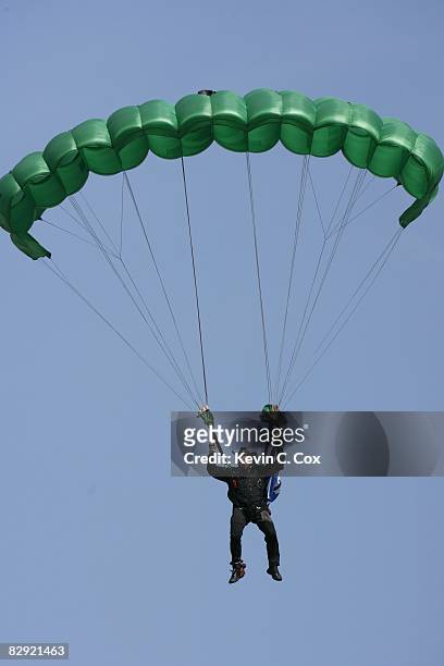 Skydiver parachutes onto the field before the Duke Blue Devils game against the Navy Midshipmen at Wallace Wade Stadium on September 13, 2008 in...