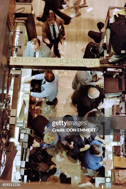 Some optimism shows on the floor of the New York Stock Exchange on October 28, 1987 both on faces and on a sign that traders posted that reads...