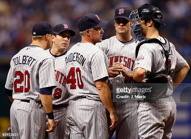 Pitching coach Rick Anderson of the Minnesota Twins has a chat with his pitcher, Nick Blackburn and catcher Joe Mauer against the Tampa Bay Rays...