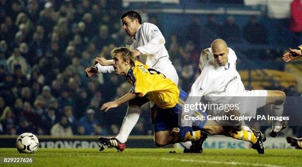 Leeds United's Ian Harte and Teddy Lucic tackle Southampton's Brett Ormerod during their FA Barclaycard Premiership match at Leeds' Elland Road...