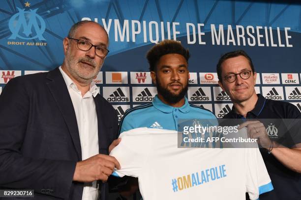 Olympique de Marseille's newly recruited player, Jordan Amavi holds his new jersey next to Olympique de Marseille French president Jacques-Henri...