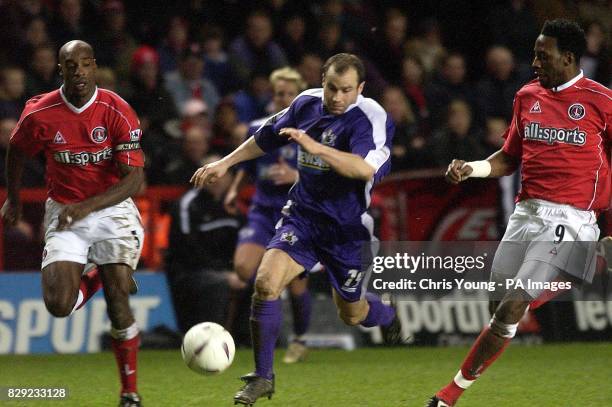 Exeter's Martin Thomas takes the ball past Richard Rufus and Jason Euell of Charlton, during their FA Cup Third Round match at Charlton's Valley...