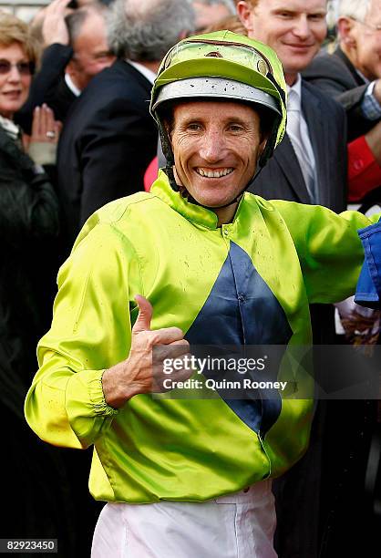 Jockey Damien Oliver, who rode Orange County, gives the thumbs up after winning the Sir Rupert Clarke Stakes during Underwood Stakes Day at Moonee...