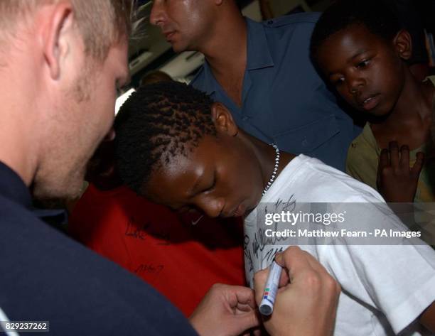 England cricketer Matthew Hoggard signs an autograph for a young South African cricket fan at Port Elizabeth airport, South Africa. England are based...