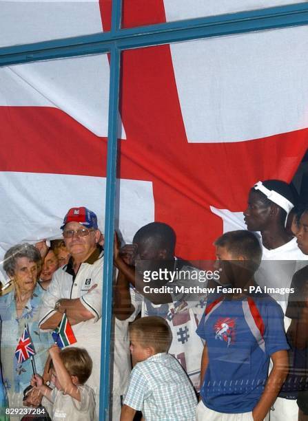English and South African cricket fans wait for the arrival of the England team at Port Elizabeth airport, South Africa. England are based in Port...