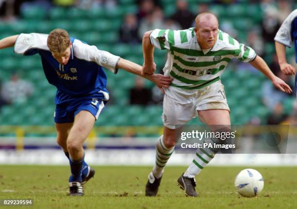 Celtic's John Hartson gets past St Johnstone's Darren Dods during their Barclaycard Premiership match at Celtic Park.