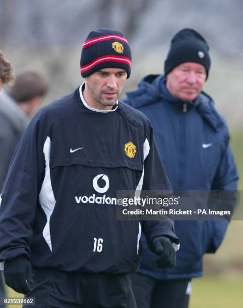Manchester United's Roy keane is watched by manager Sir Alex Ferguson in a training session at the Carrington training ground, Manchester, prior to...