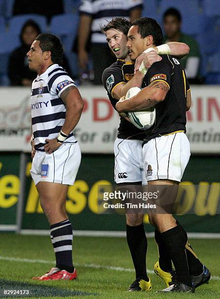 Cory Jane of Wellington celebrates with team mate Hosea Gear after he scored a try as David Smith of Auckland shows his disappointment during the Air...