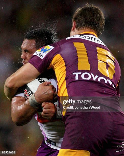 Jeff Lima of the Storm is tackled by Ashton Sims of the Broncos during the NRL semi final two match between the Brisbane Broncos and the Melbourne...