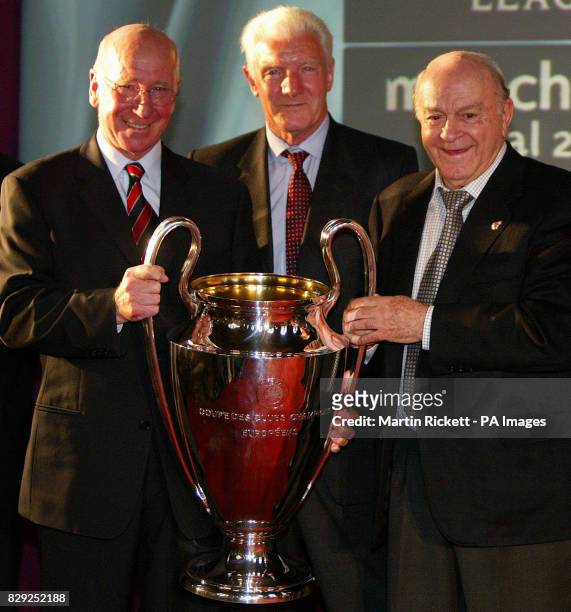 Former Manchester United players Bobby Charlton and Bill Foulkes recieve the Champions league trophy, from Real Madrid's Alfredo Di Stefano as...