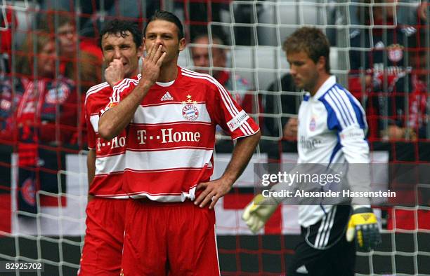 Mark van Bommel of Bayern Muenchen and his team mates Martin Demichelis and Michael Rensing looking dejected after the 5th goal during the Bundesliga...